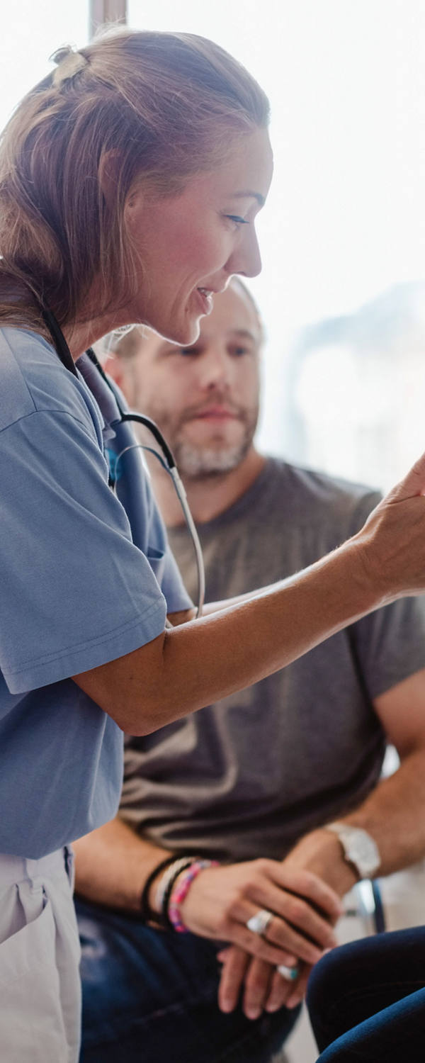 Doctor examines young patient in doctor’s office.