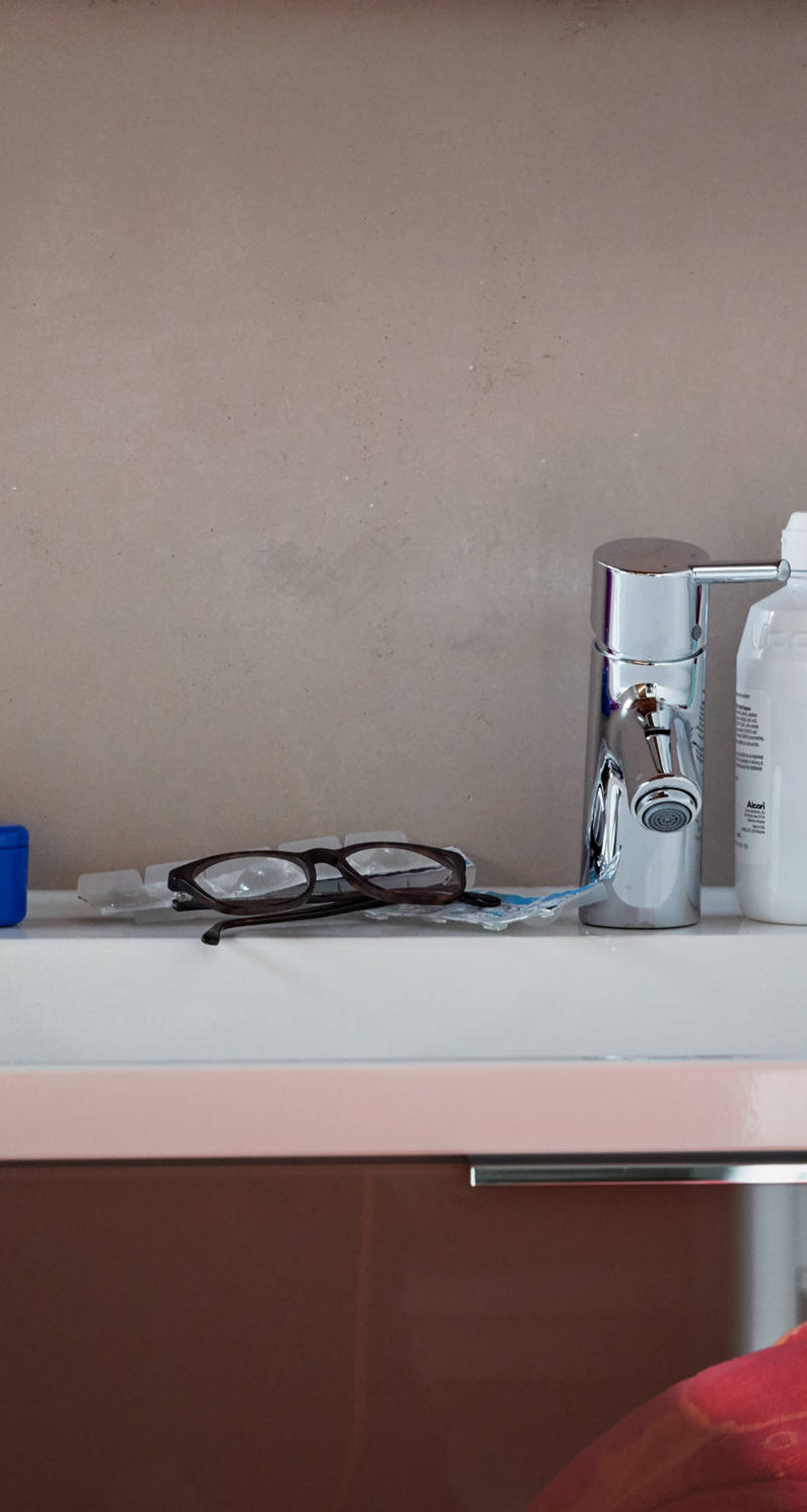 Bathroom sink with toothbrush, braces and glasses