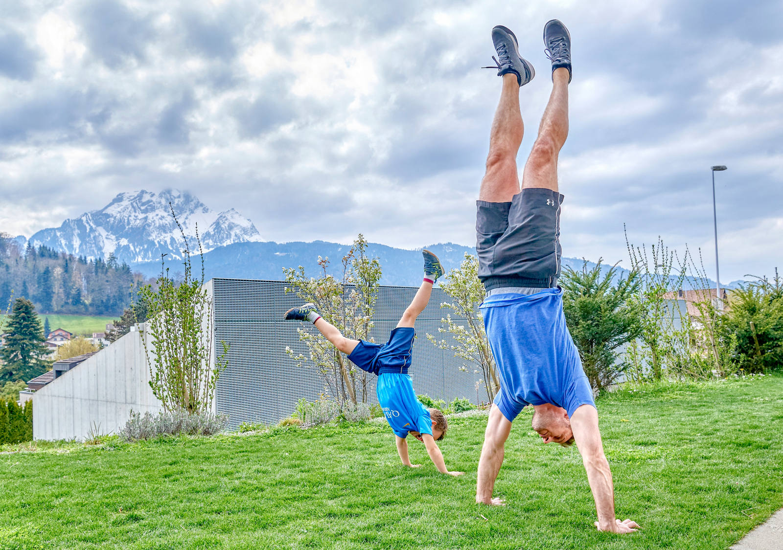 Father and son practise handstand