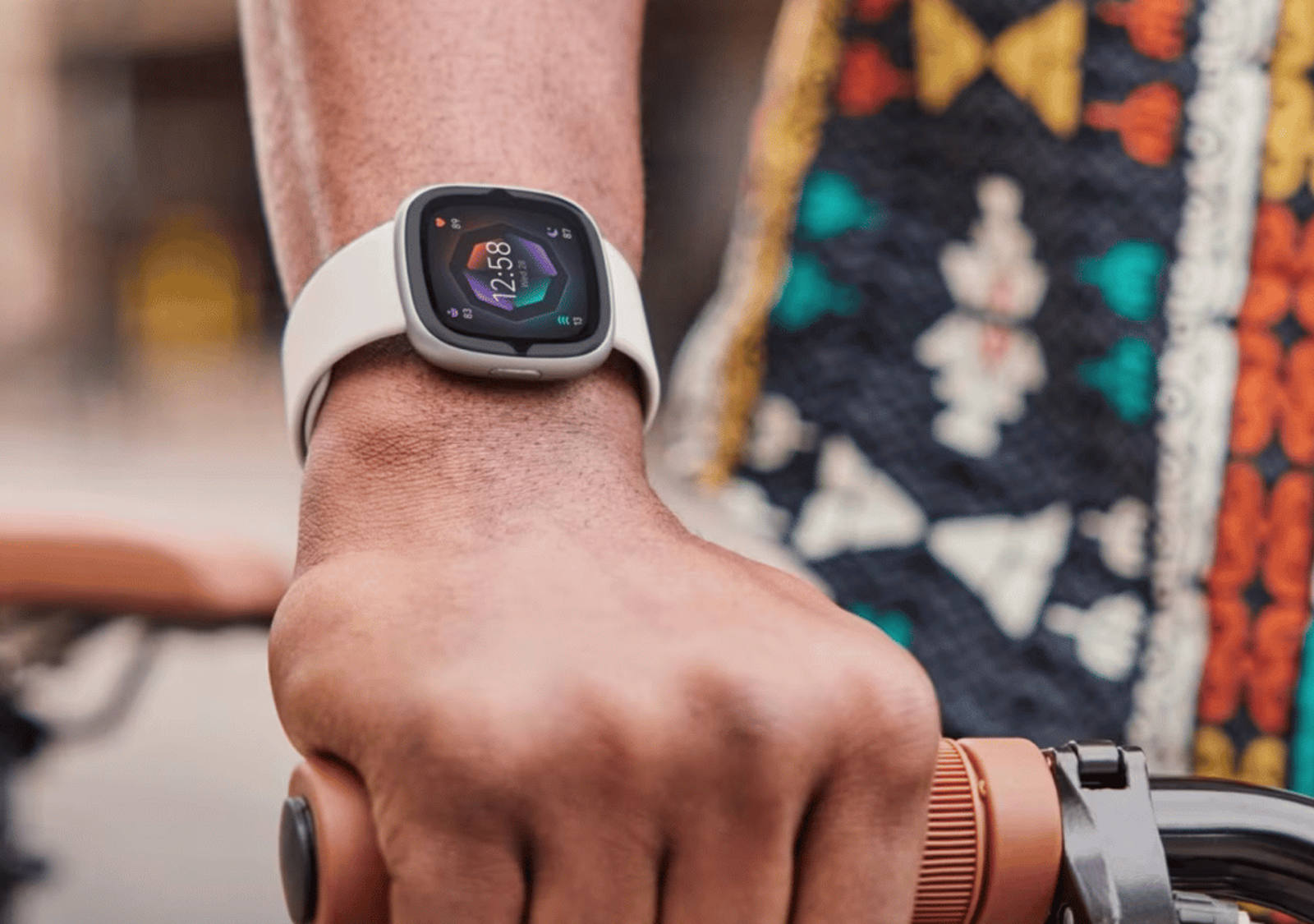 Smartwatch from Fitbit on the wrist of a cyclist.