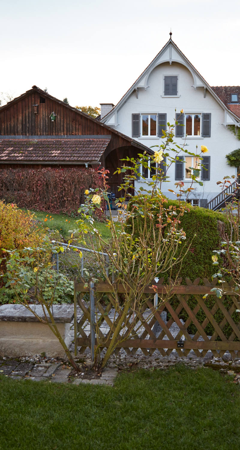 Woman pouring flowers around her house