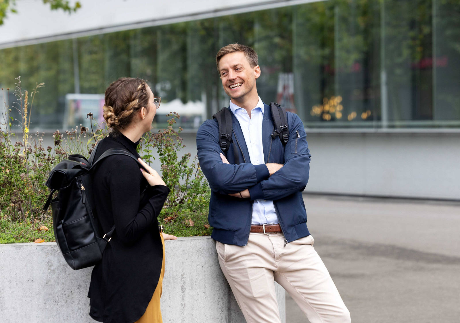 Two CSS employees talk in front of the main office.