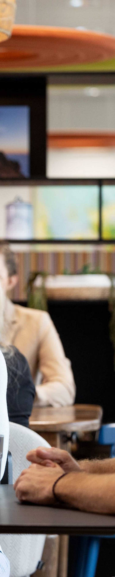 CSS employees sit in the CSS cafeteria talking.