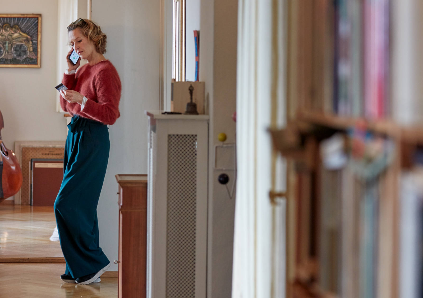 Woman on the phone in front of her cello