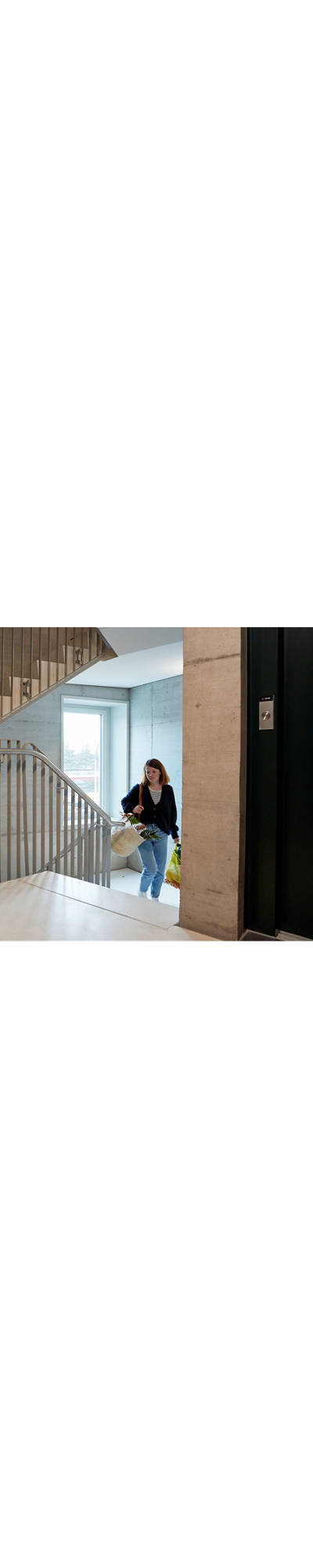 Woman with shopping in stairwell