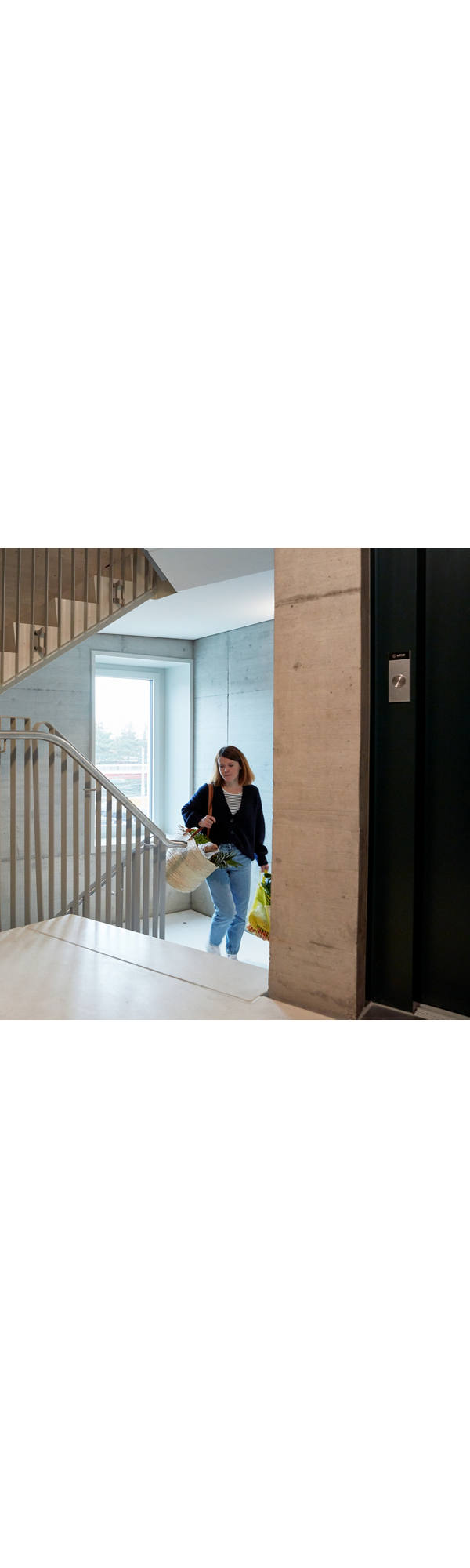 Woman with shopping in stairwell