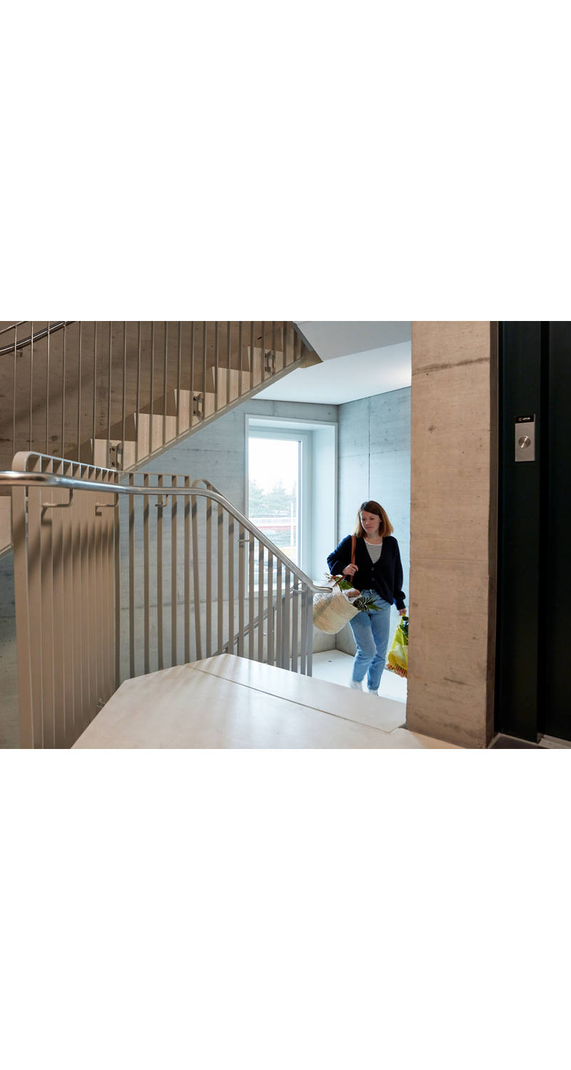 Woman with shopping in stairwell