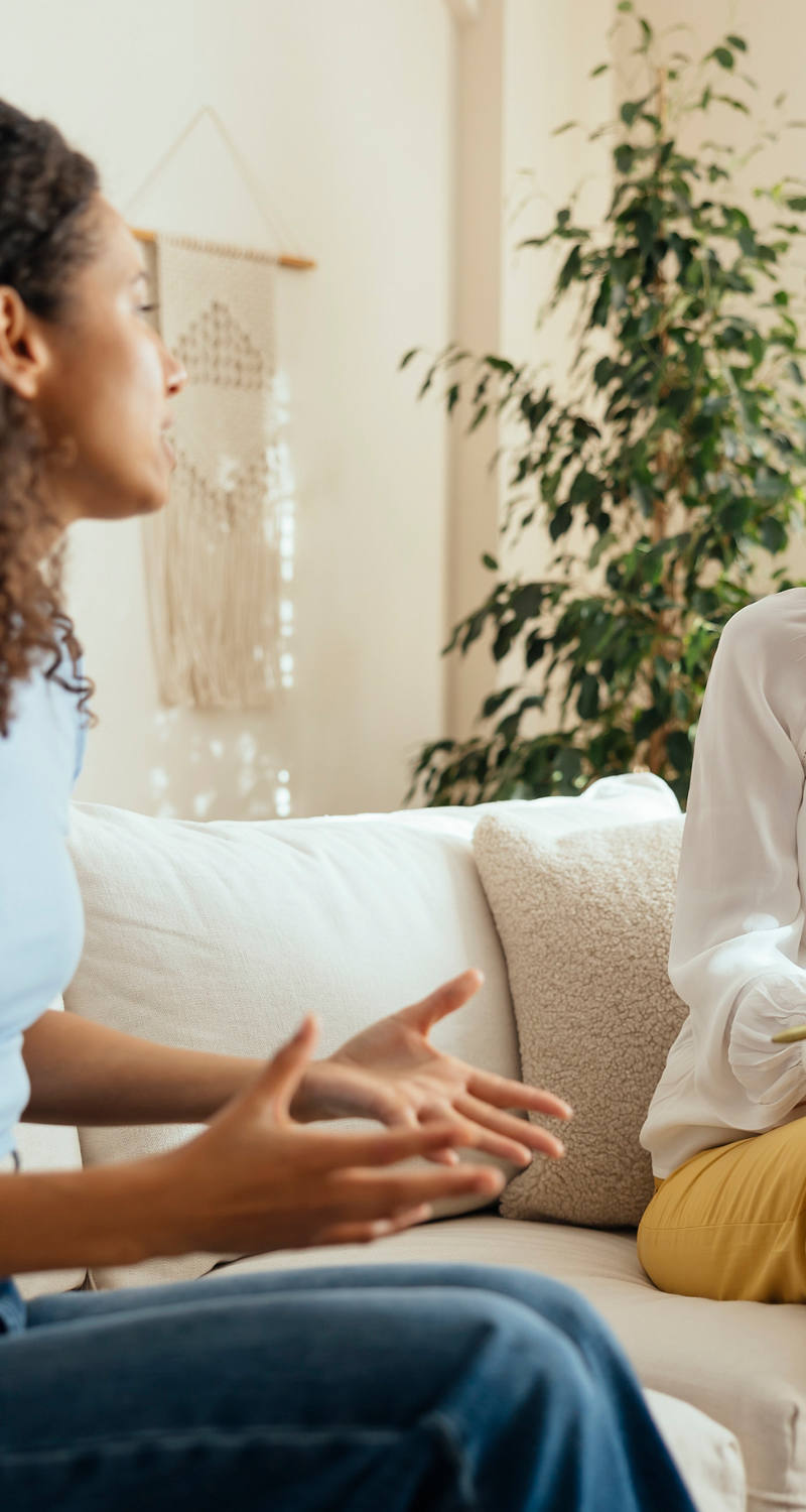  Two women talking on the couch