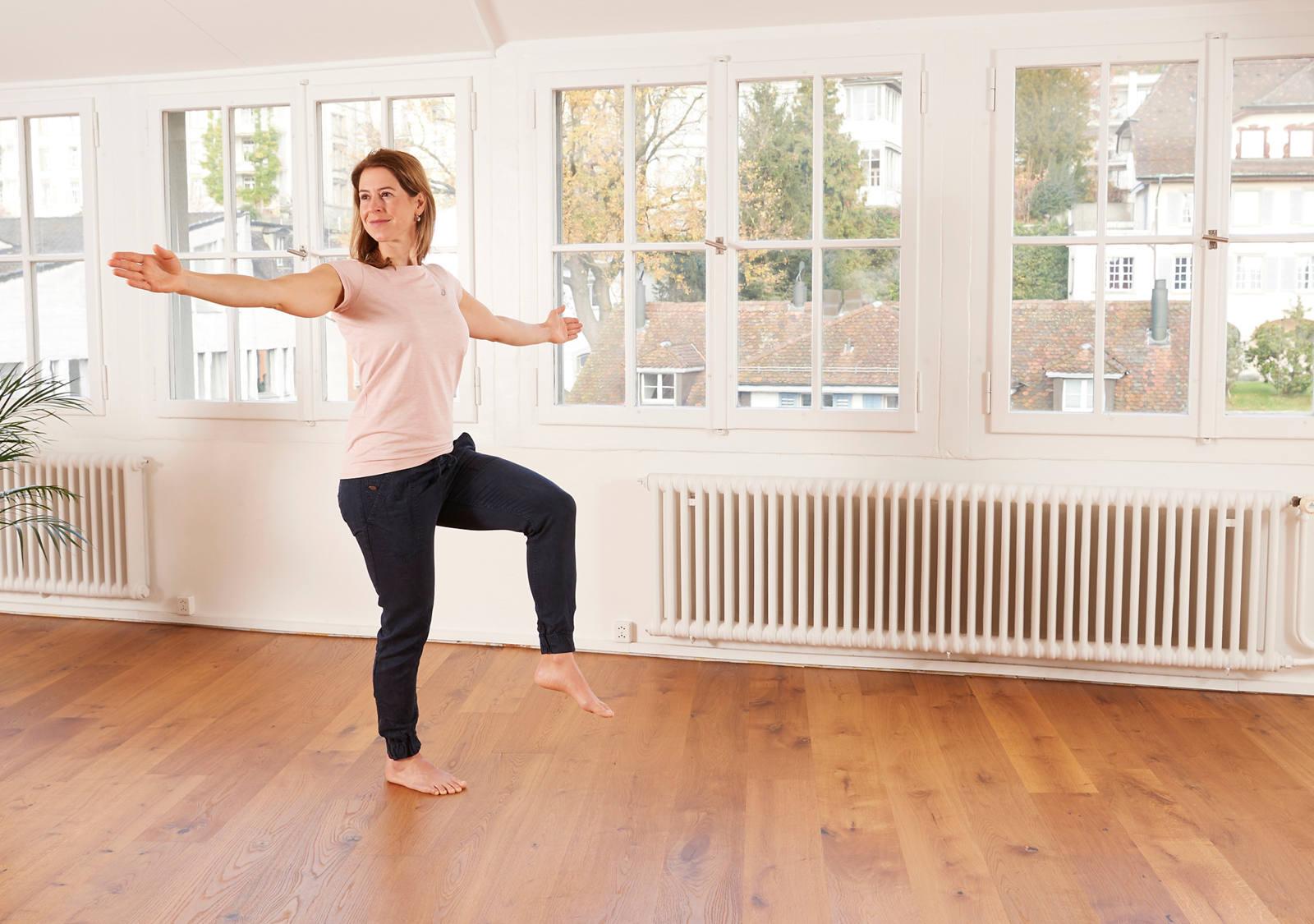 A woman does balance exercises.