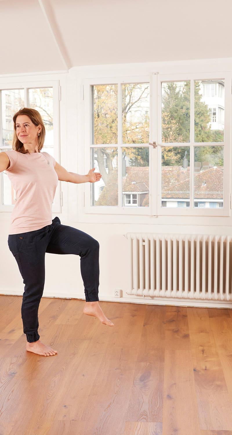A woman does balance exercises.