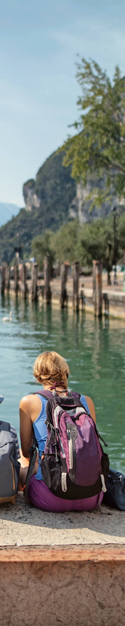 Famille assise sur un mur devant un lac