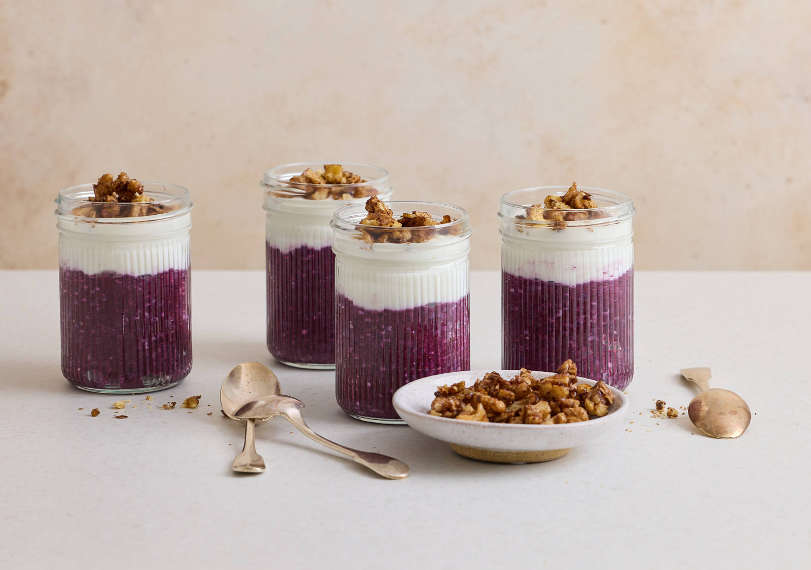 Bilberry and chia pudding served in preserving jars.