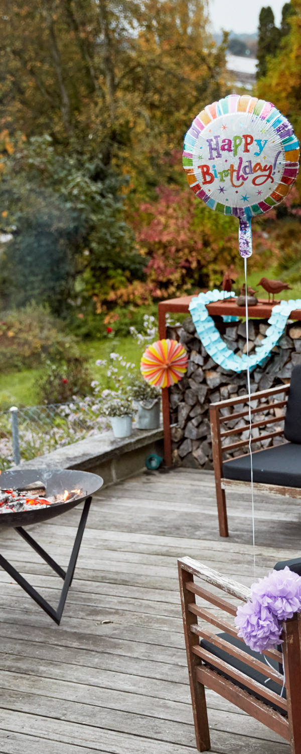 Uomo decora la terrazza per una festa di compleanno