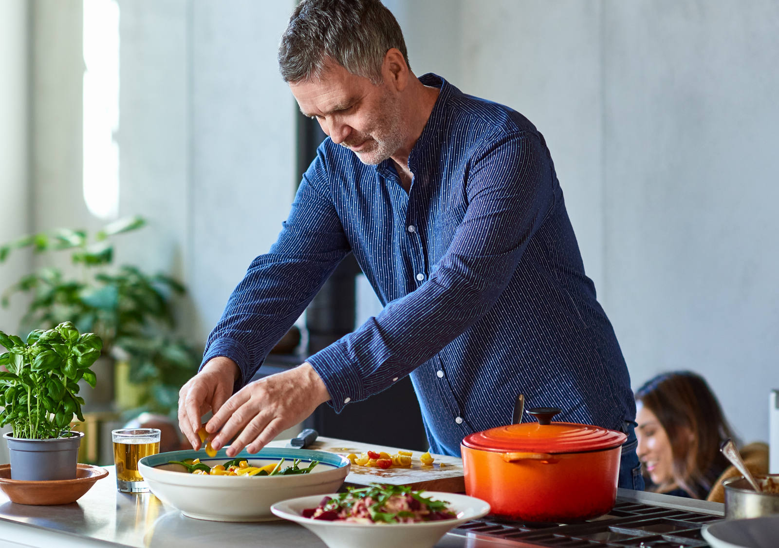 Man preparing food in kitchen.