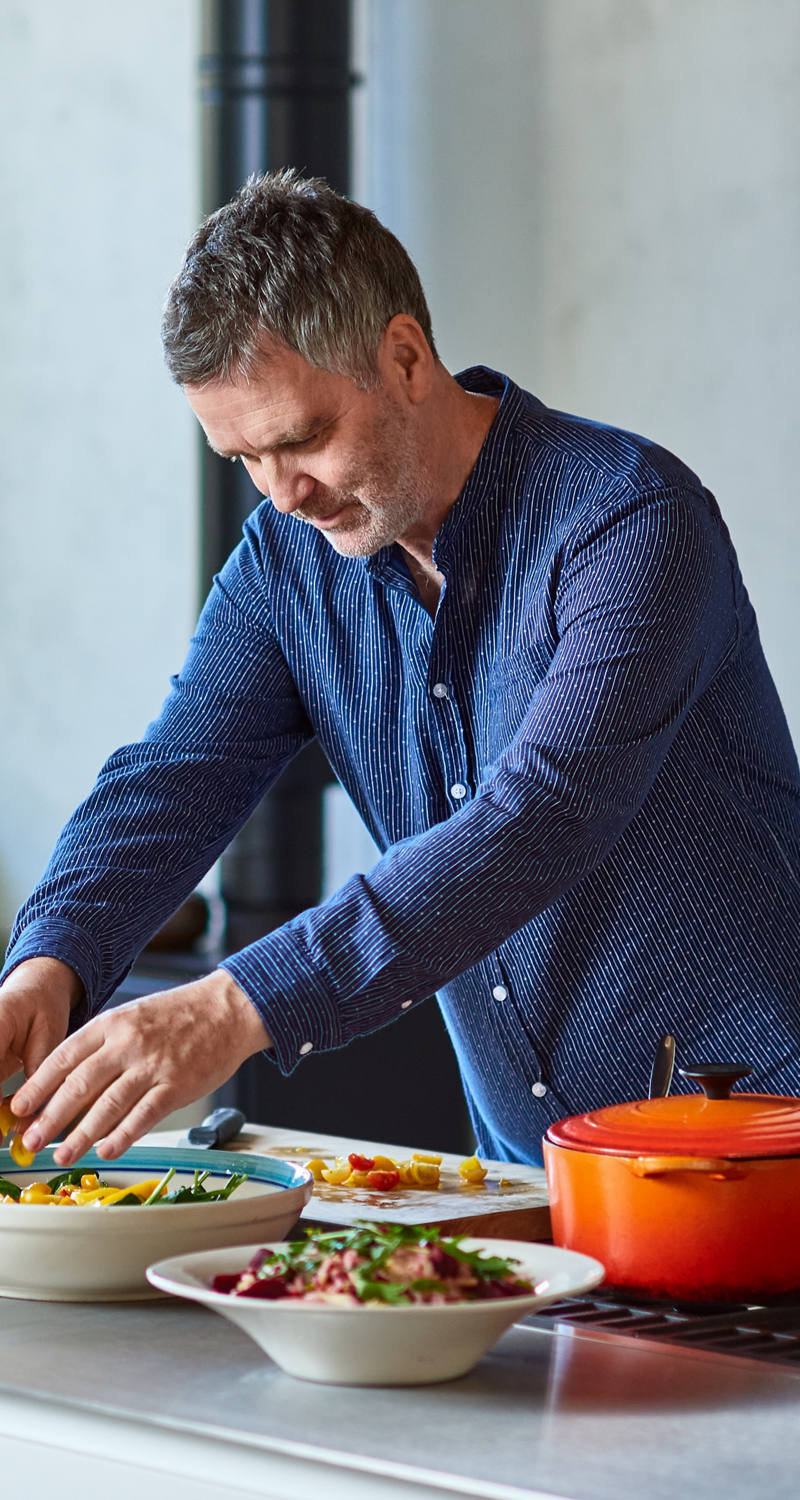 Man preparing food in kitchen.