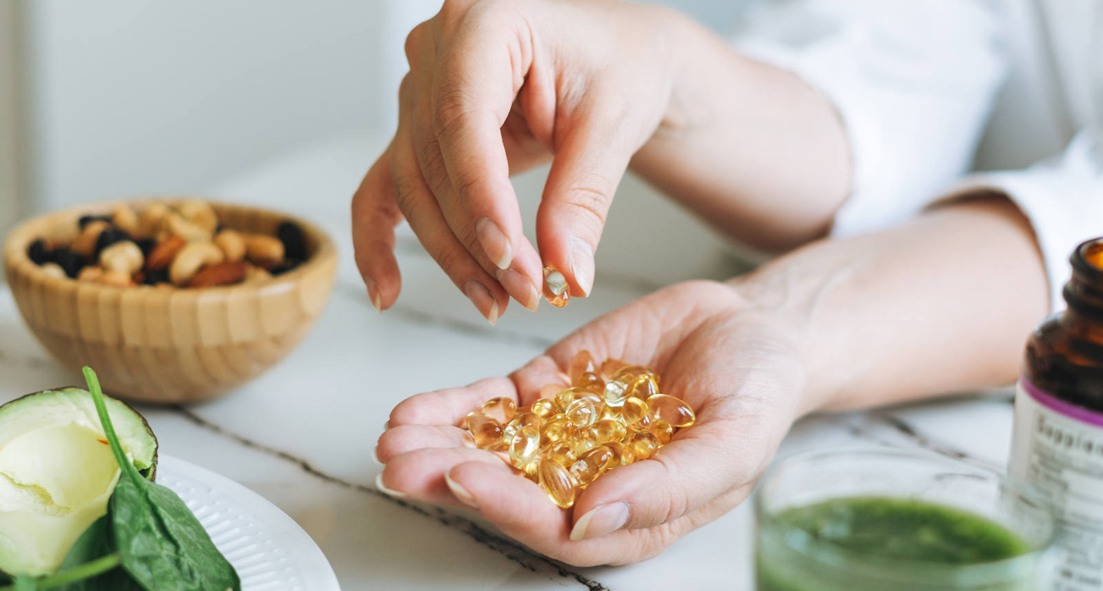 Woman holding dietary supplement pills in hands