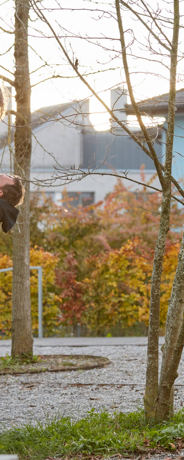 Father plays with daughter on playground.