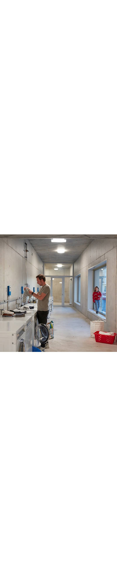 Man washing laundry in a laundry room