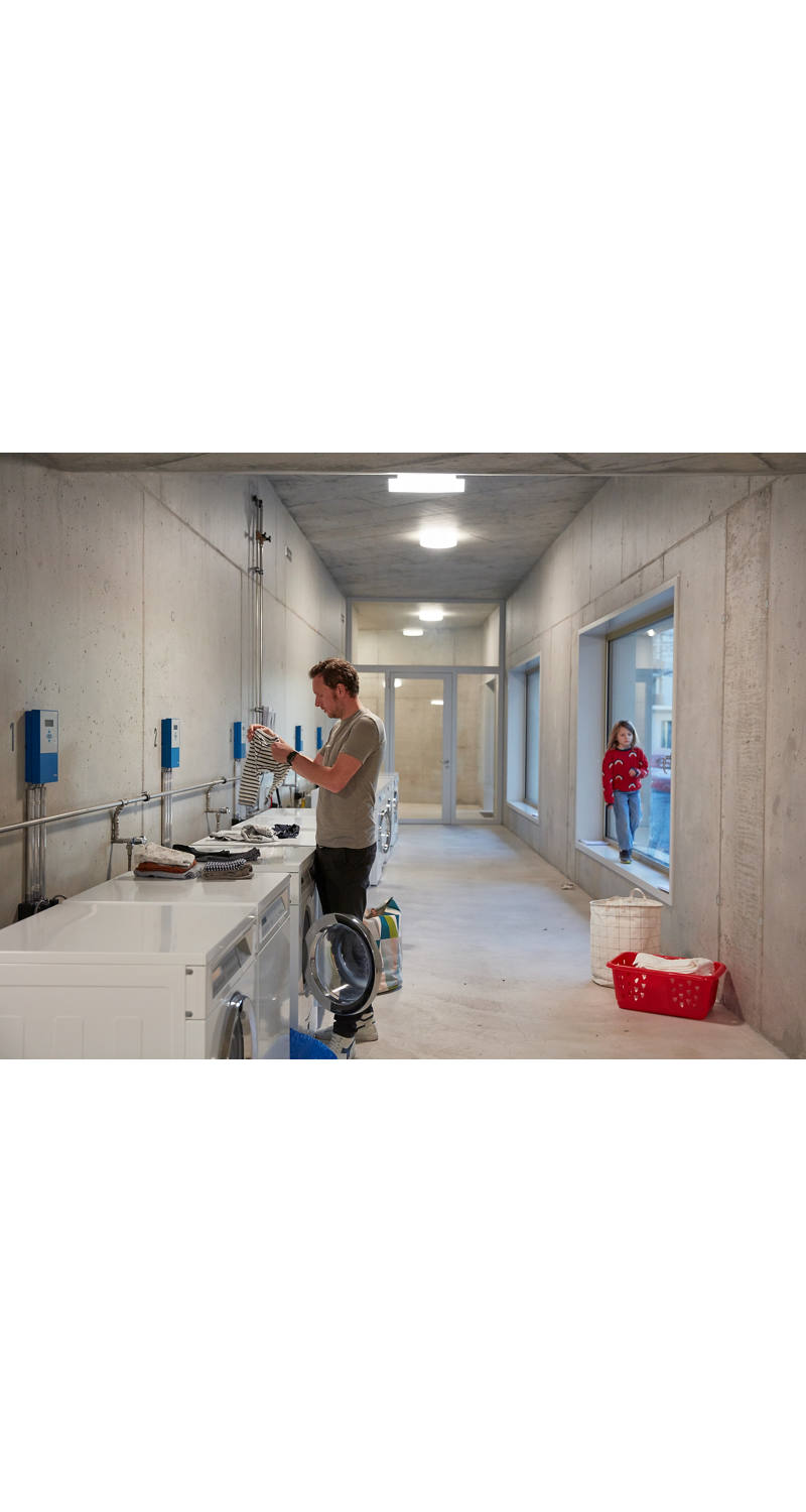 Man washing laundry in a laundry room